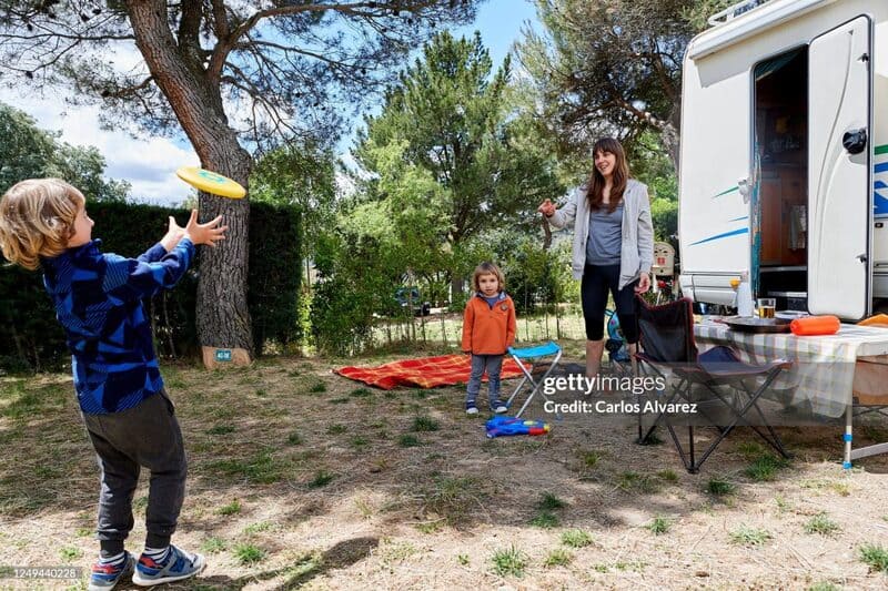 GARGANTILLA DE LOZOYA, SPAIN - JUNE 13: A family enjoys a weekend with their motorhome at the Monte Holiday campsite on June 13, 2020 in Gargantilla de Lozoya y Pinilla de Buitrago, Spain. The campsite, which had to close during the country's months-long coronavirus lockdown, has a capacity for 1,200 people and is completely booked for every weekend from mid-July through August. They have an average of 4,000 daily visits on the web and are seeing a large increase in people who come with motorhomes. (Photo by Carlos Alvarez/Getty Images)