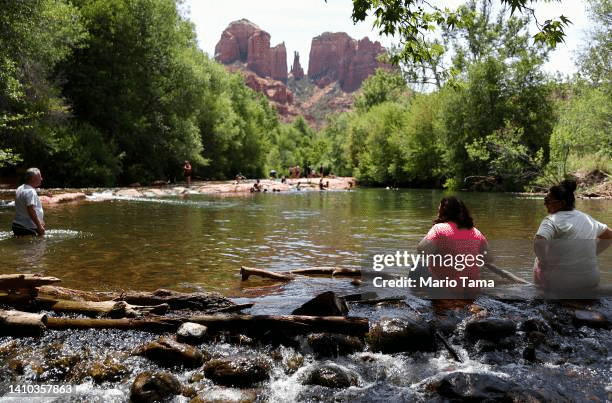 People cooling off in Oak Creek in Sedona, Arizona, a popular fall destination for travel.