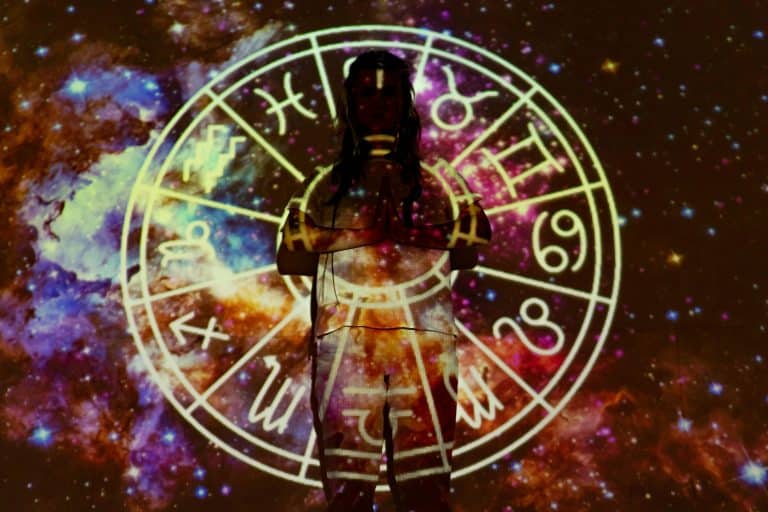 Silhouette of a person with celestial astrology symbols against a cosmic background. Sagittarius
