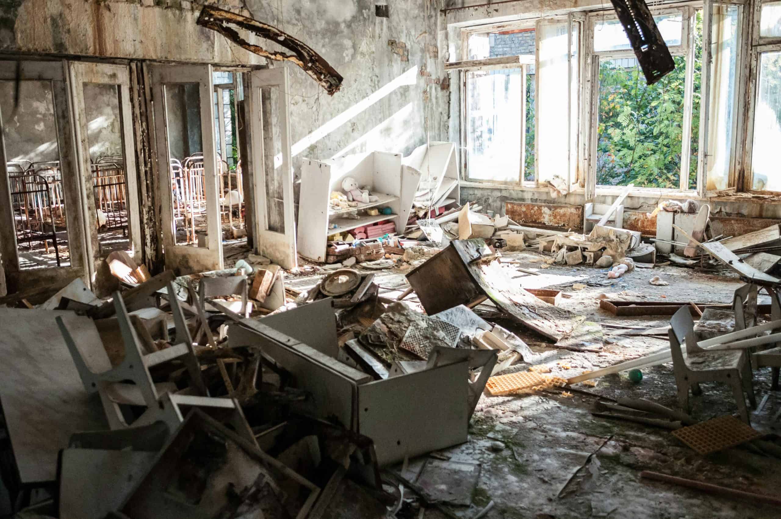 A desolate room filled with decayed furniture, debris, and broken windows, illustrating urban decay. Little hurricane-proofing