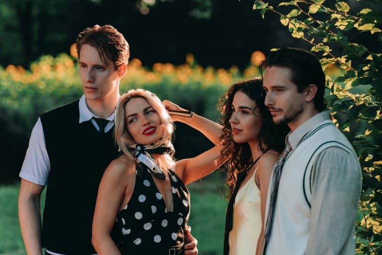 Four fashionable friends enjoying a sunny day in a garden setting. narcissism epidemic