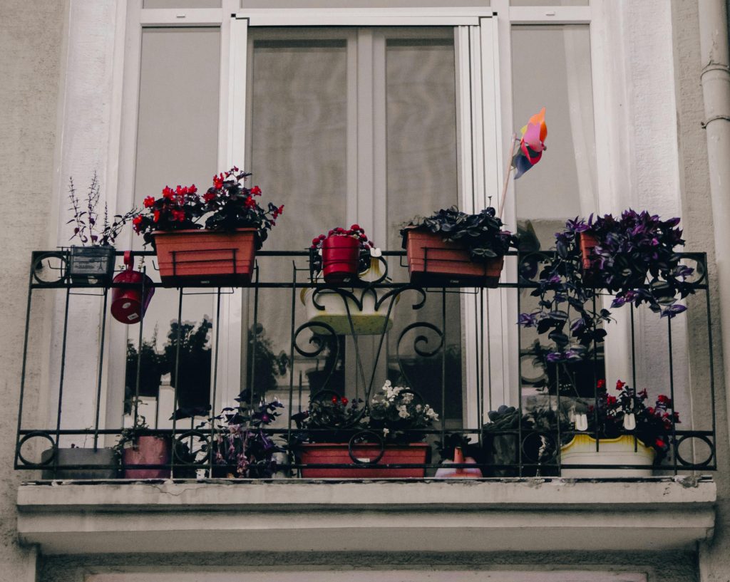 A picturesque balcony in Istanbul adorned with colorful potted plants, adding a touch of nature.