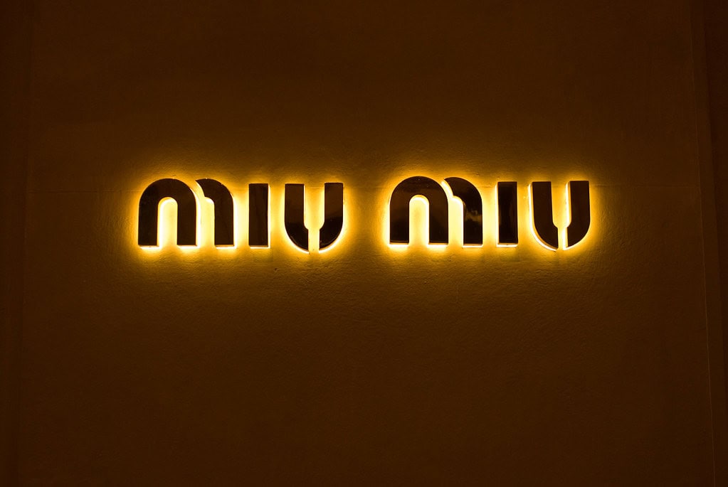 This is a photograph of the Miu Miu logo. The Arcadie handbag is a popular Miu Miu item.