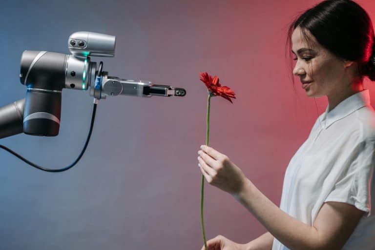 A woman interacts with a robotic arm holding a flower, symbolizing human-technology harmony. relationships with AI,LLM
