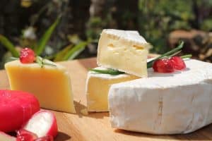 This is a photograph of a cheese display. A cheese board can be a convenient and enticing option for fall guests.